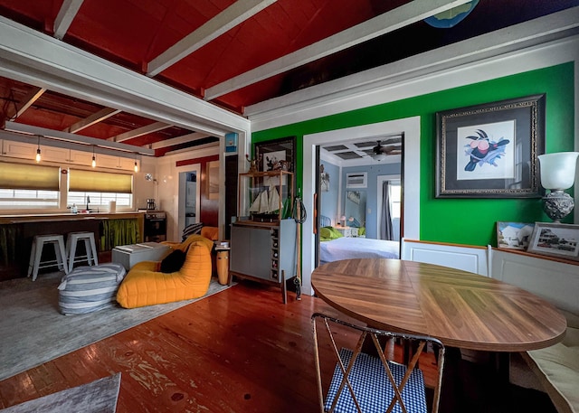 dining space featuring hardwood / wood-style flooring, ceiling fan, sink, and beamed ceiling