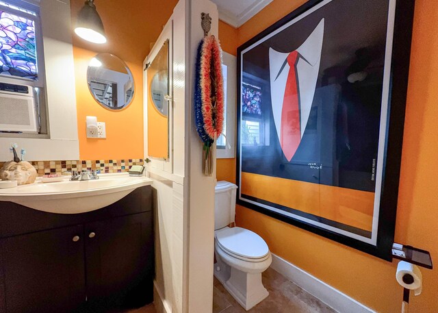 bathroom with tasteful backsplash, vanity, and toilet