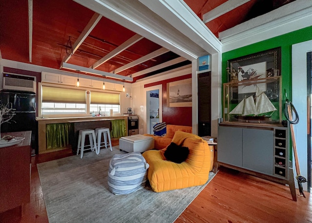 interior space with hardwood / wood-style flooring and beamed ceiling