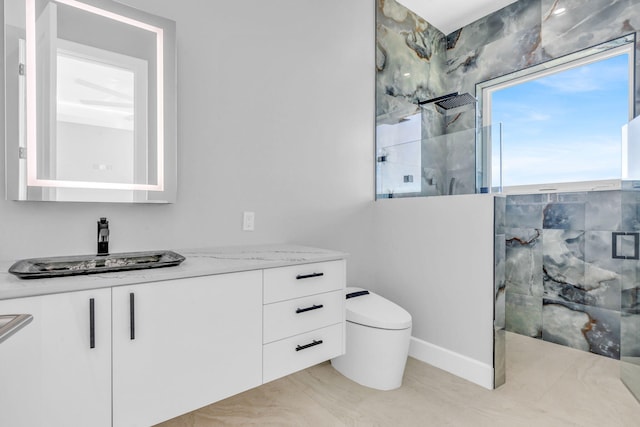 bathroom featuring vanity, a shower with shower door, and toilet