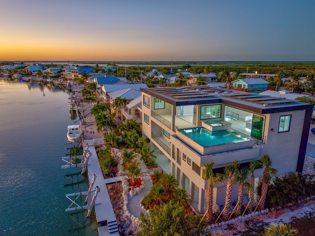 aerial view at dusk with a water view