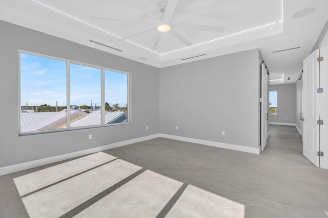 empty room with a barn door and concrete flooring