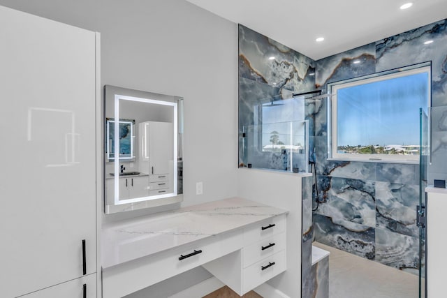 bathroom featuring vanity and an enclosed shower