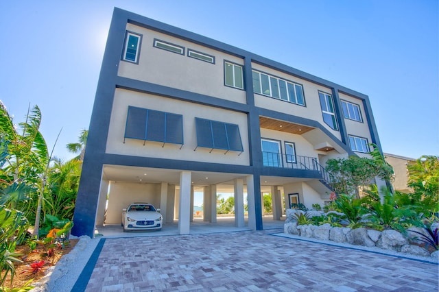 back of property featuring a carport