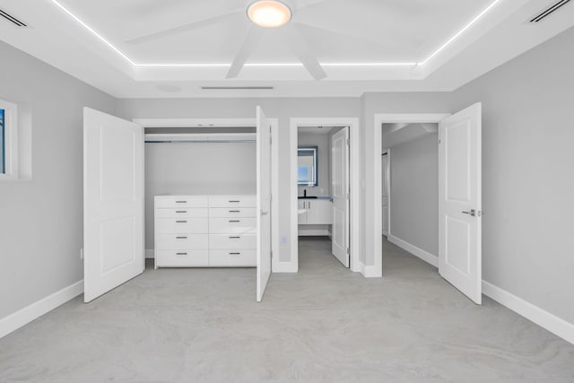 unfurnished bedroom featuring ensuite bath and a closet