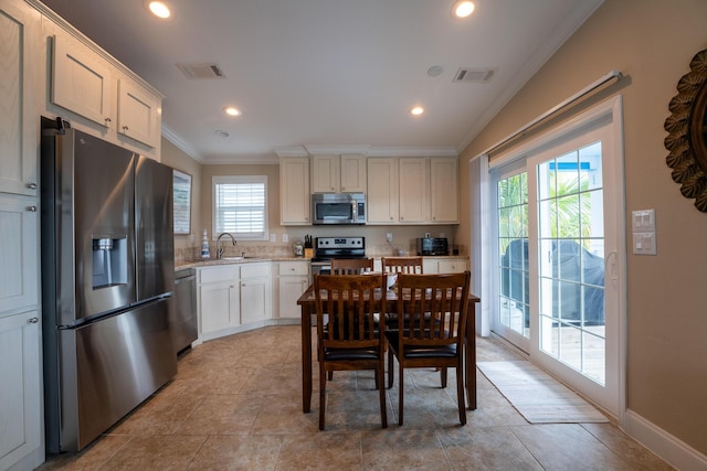 kitchen with white cabinetry, sink, crown molding, and appliances with stainless steel finishes