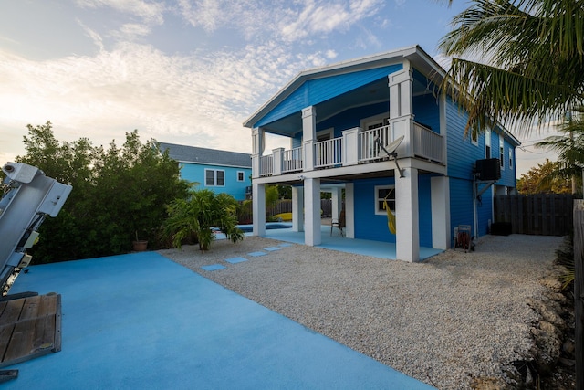 back of property with a patio area and a balcony