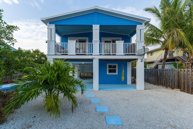 coastal home featuring a patio and a balcony