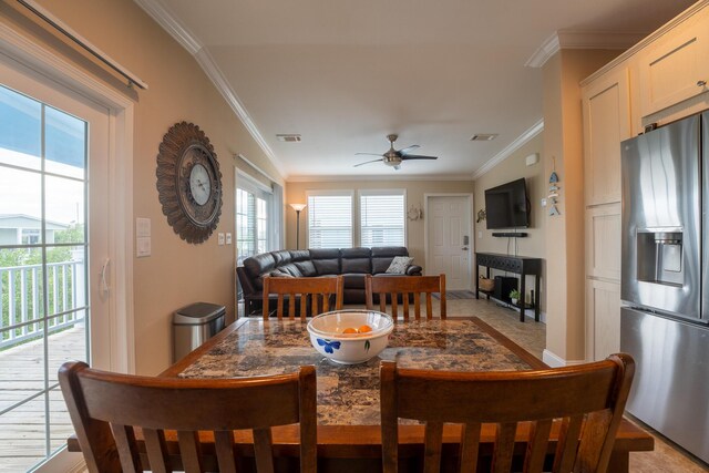 dining room with ceiling fan, ornamental molding, and plenty of natural light