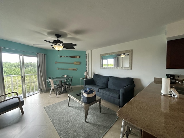 living room featuring light tile patterned floors and ceiling fan