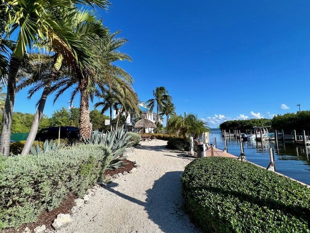 view of yard featuring a water view and a boat dock