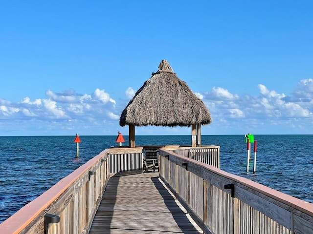 view of dock with a gazebo and a water view