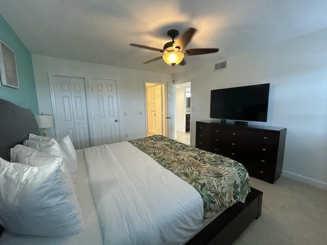 bedroom featuring two closets and ceiling fan