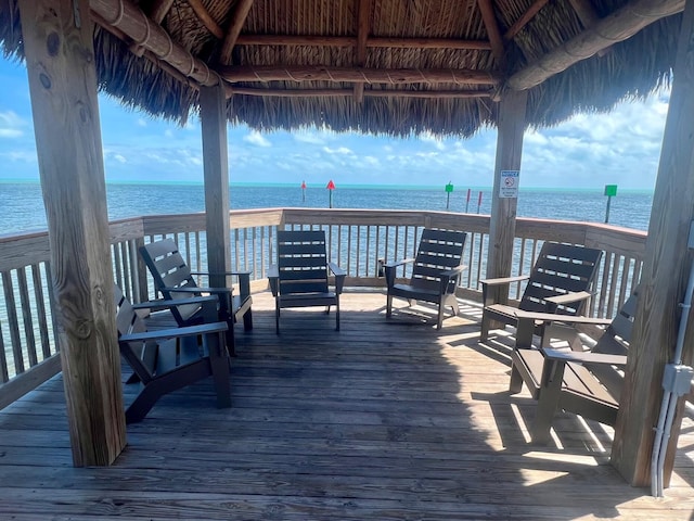 wooden terrace featuring a gazebo and a water view