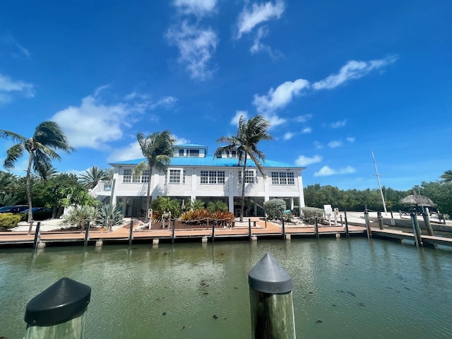 view of dock featuring a balcony and a water view