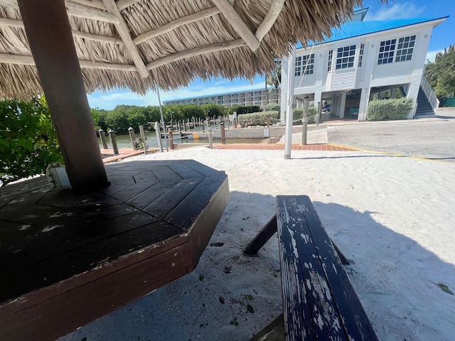 view of community featuring a gazebo, a water view, and volleyball court