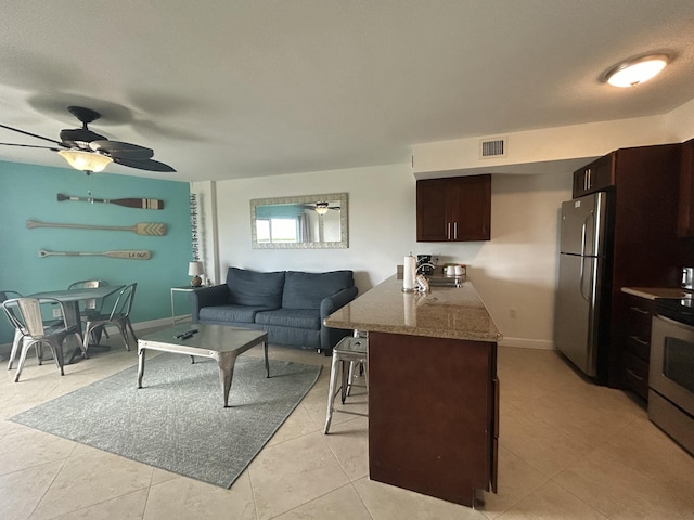 living room with ceiling fan and light tile patterned floors