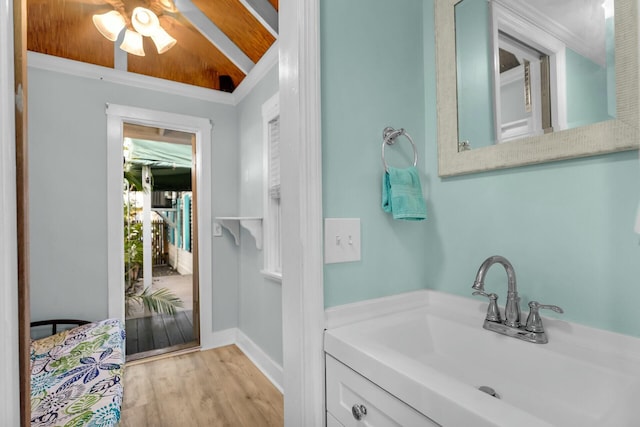 bathroom with a ceiling fan, a sink, baseboards, and wood finished floors