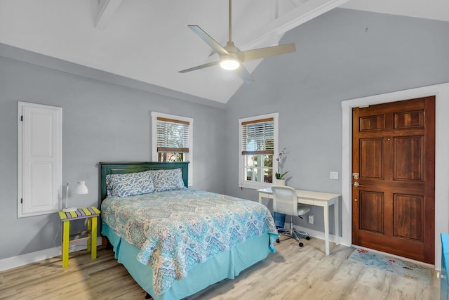 bedroom with a ceiling fan, lofted ceiling, baseboards, and wood finished floors