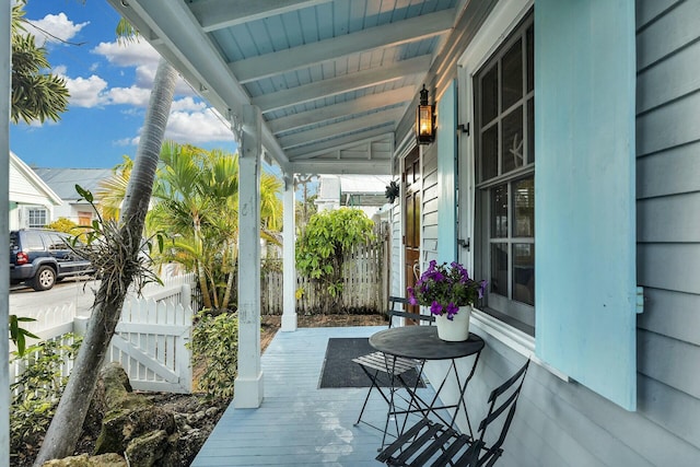 view of patio / terrace with a porch and fence