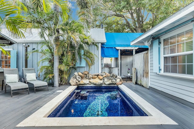 view of swimming pool featuring a deck