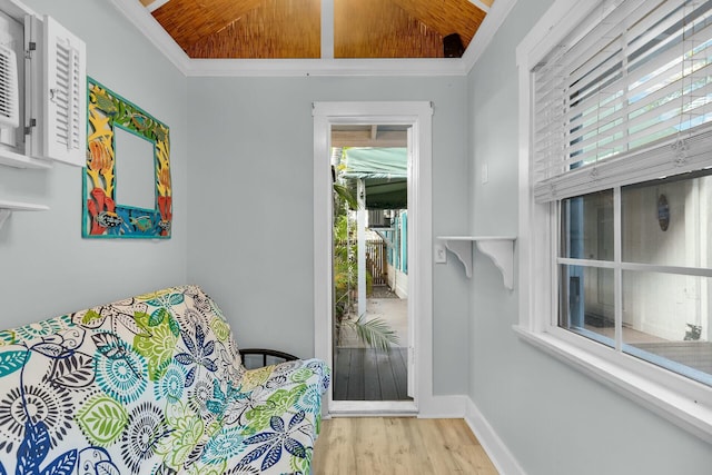 bedroom with crown molding, lofted ceiling, wood ceiling, wood finished floors, and baseboards