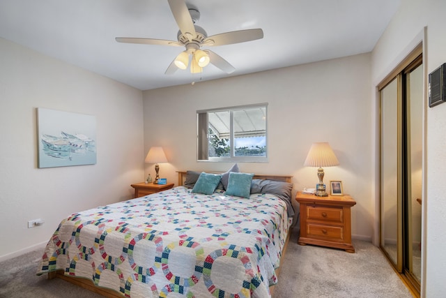 carpeted bedroom featuring ceiling fan, a closet, and baseboards