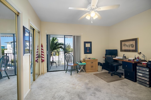 home office with carpet and a ceiling fan