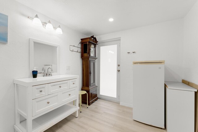 bathroom with vanity and wood-type flooring