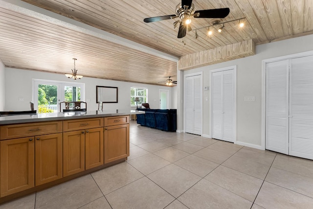 kitchen featuring light tile patterned flooring, ceiling fan, wood ceiling, and hanging light fixtures