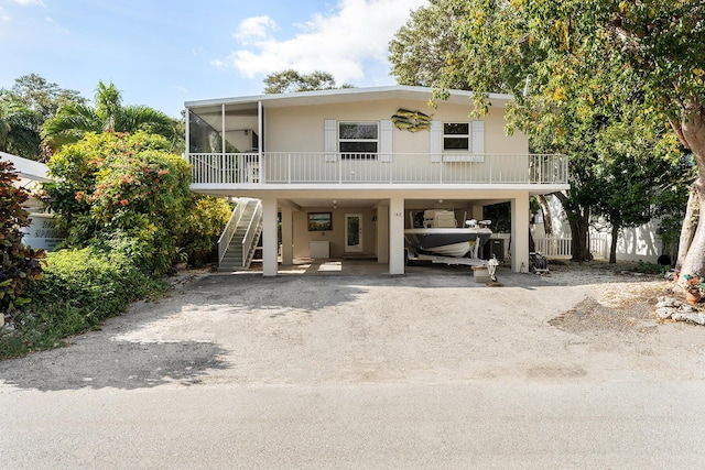 raised beach house featuring a carport