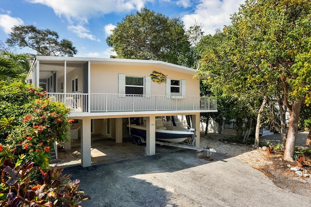 view of front facade featuring a carport and a sunroom