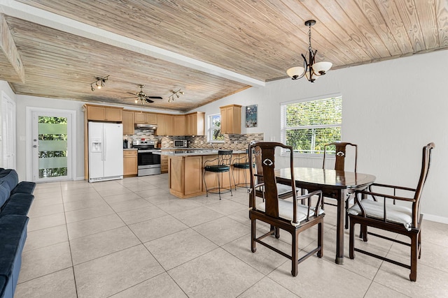 dining space featuring wood ceiling and light tile patterned floors