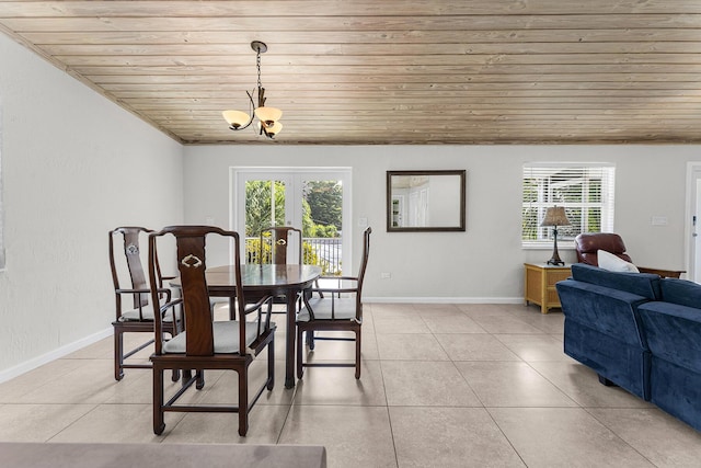 dining area featuring an inviting chandelier, light tile patterned floors, wood ceiling, and french doors