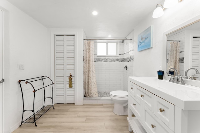 bathroom with vanity, hardwood / wood-style flooring, a shower with curtain, and toilet