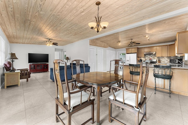 tiled dining space with ceiling fan with notable chandelier and wooden ceiling