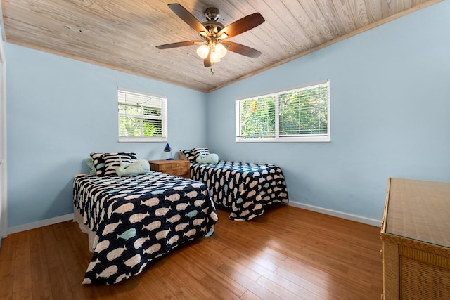 bedroom with hardwood / wood-style flooring, ceiling fan, wood ceiling, and vaulted ceiling