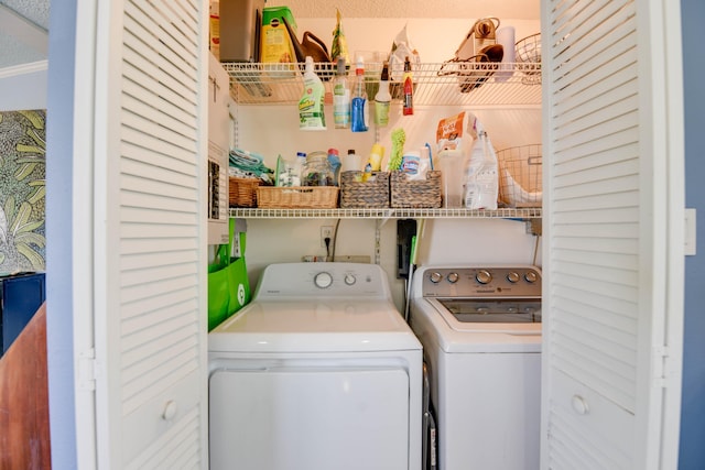 clothes washing area featuring independent washer and dryer and a textured ceiling