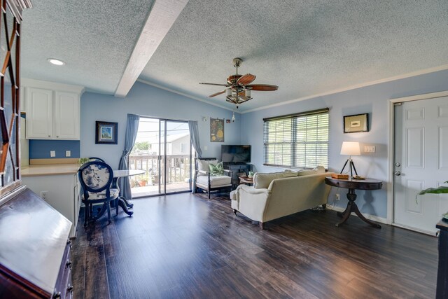 living room with vaulted ceiling, dark hardwood / wood-style floors, ornamental molding, ceiling fan, and a textured ceiling