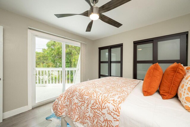 bedroom with access to exterior, a ceiling fan, baseboards, and wood finished floors