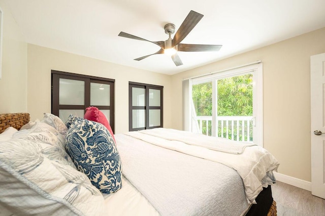 bedroom with ceiling fan, baseboards, and wood finished floors