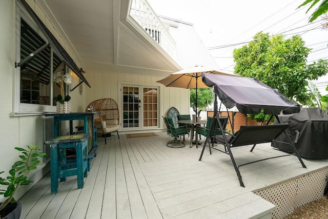 wooden deck featuring outdoor dining area