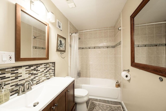 bathroom featuring visible vents, backsplash, toilet, shower / tub combo, and vanity