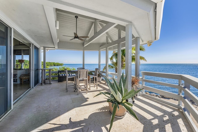 view of patio with ceiling fan and a water view