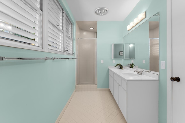 bathroom featuring vanity, a shower with shower door, and tile patterned flooring