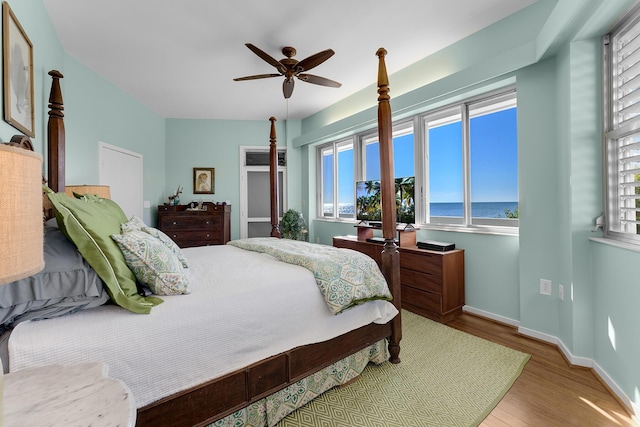 bedroom with light hardwood / wood-style flooring and ceiling fan