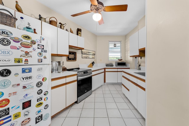 kitchen featuring white cabinetry, light tile patterned flooring, ceiling fan, and appliances with stainless steel finishes