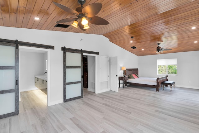 bedroom with a barn door, wooden ceiling, vaulted ceiling, baseboards, and light wood-type flooring