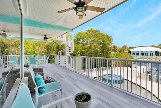 wooden terrace featuring a ceiling fan