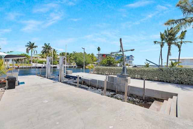 dock area with a water view and boat lift